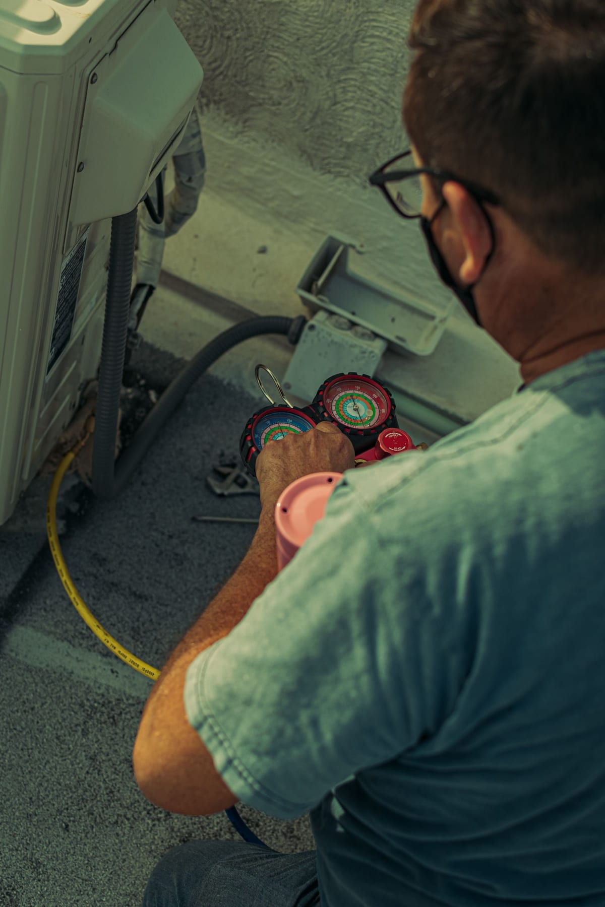 Technician diagnosing a heating system with gauges
